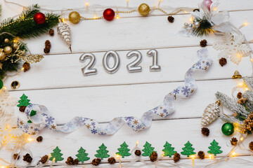 White Christmas background decorated with festive decor, lanterns, snowflakes and Christmas tree branches. Christmas greeting card. Winter holiday season. Happy New Year