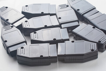 Bunch of OBD2 car scanners and diagnostic interfaces. OBDII professional car scanner. Spare part background texture.