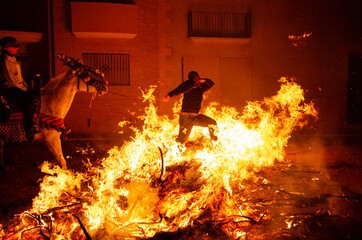 Fototapeta premium Traditional festival of S. Antoni, where horses and people jump over the fire