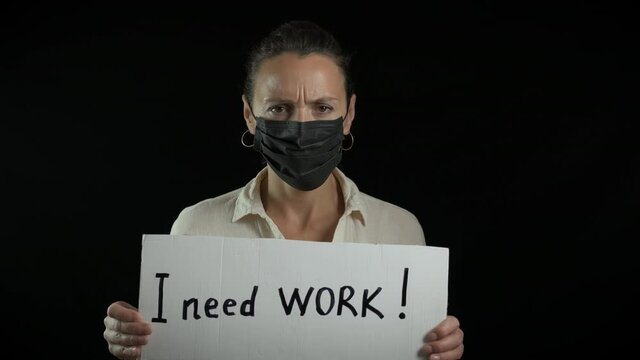 Workless during epidemic. A workless desperate woman in medical mask looking for a job in quarantine.