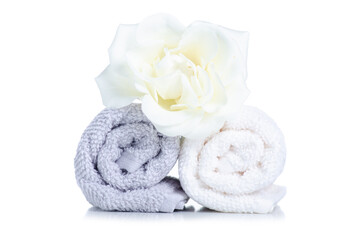 Fototapeta na wymiar Stack rolled hand towels with flower rose on white background isolation