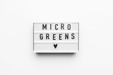 Lightbox with microgreens text on white background