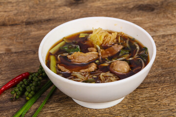 Thai style soup with meat and mushrooms