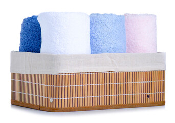 Rolled towels in laundry basket on white background isolation