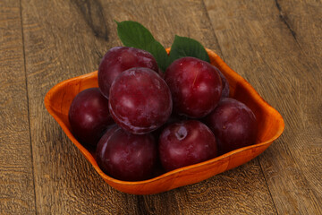 Plum heap in the wooden basket