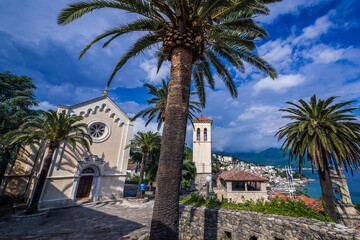 Fototapeta na wymiar St Jerome church and tower on one of the squares of historic part of Herceg Novi, Montenegro