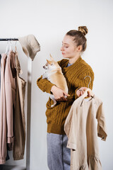 Small business, Fashion designer workplace, Tailoring Shop. Fashion Designer with pet dog Working In Her Studio. Beautiful female designer working in atelier with fabrics