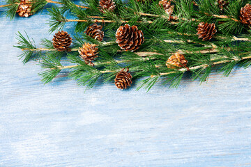 Happy New Year greeting card. Christmas branches on rustic wooden background. Space for text. Top view