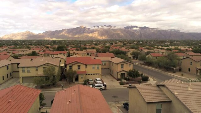 Rising drone shot of homes and mountains in Tucson Arizona