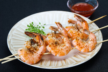 Grilled prawn skewer with sauce