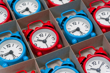 Colored clock alarm clocks in a cardboard box