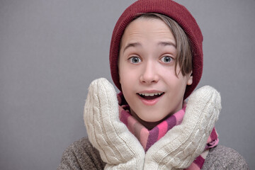 boy wearing a scarf, hat and gloves and smiling and happy, the concept of good immunity, feel good in the cold season