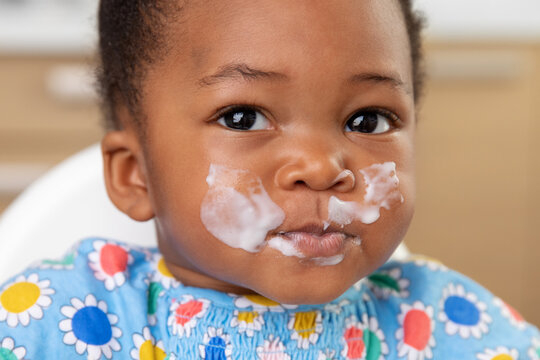 Close Up Portrait Of Funny Baby Girl With Milky Face