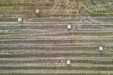 Drone high angle view of straw bales on a field around small Jaczew village, Gmina Korytnica, Mazovia Province of Poland