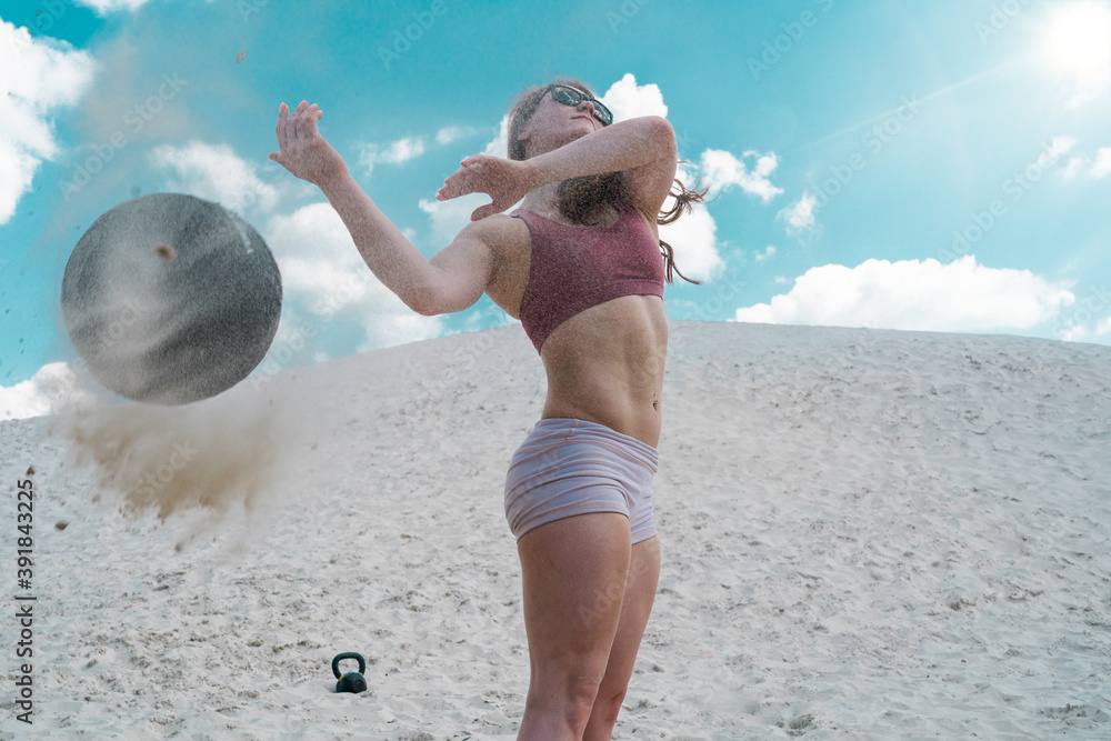 Wall mural woman a crossfit beach workout