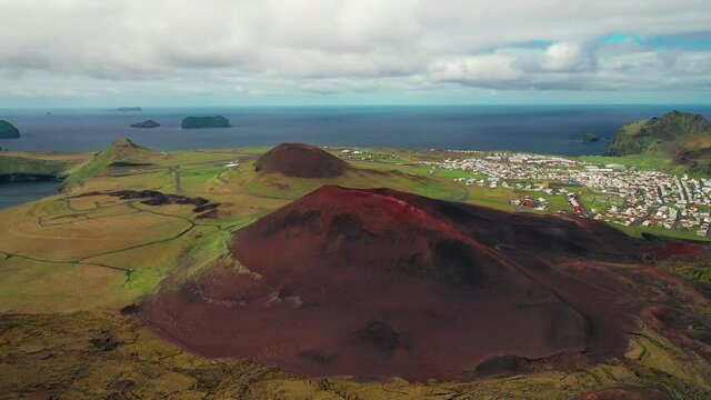 Scenic Nature's View With Volcanic Estuary On Meadows And Cityscape At Background In Westman, South Iceland. - Aerial Shot