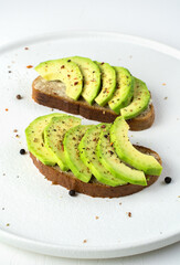 Two avocado sandwiches on a light background. The concept of proper nutrition.