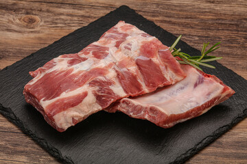 Raw pork ribs served rosemary