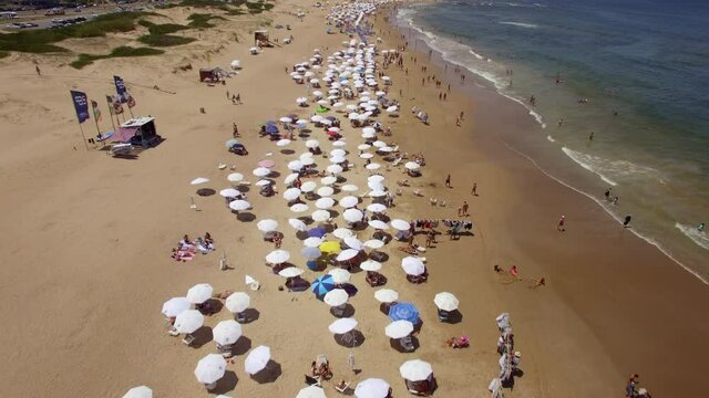 Aerial view of people enjoying the summer at famous Playa Brava beach in Punta del Este, Maldonado Department, Uruguay.