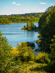 Beautiful view of forest lake Puzhanier in sunny summer day.