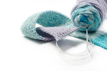 Knitting and clew of yarn isolated on white with copy space.