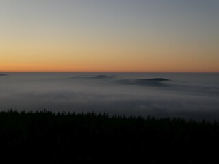 Fototapeta na wymiar sunrise above the clouds of inversion i the valley