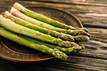 Fresh green asparagus on wooden background
