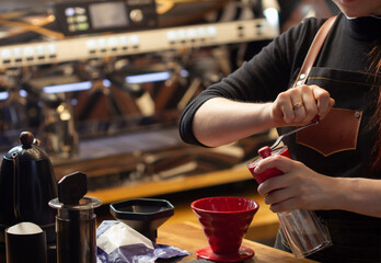 Fototapeta na wymiar Barista barista grind coffee with a grinder make beverage Alternative pure over method.