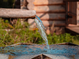 Holy spring and wooden house with plunge font pool for ablutions, relaxing in a natural park.