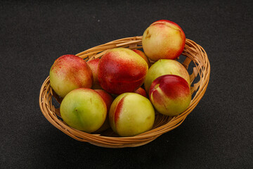 Sweet small nectarines in the basket