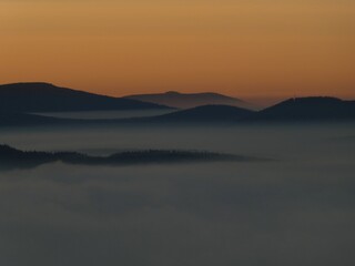 Naklejka na ściany i meble sunrise above the clouds of inversion i the valley