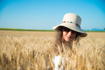 A girl in shorts and a hat in the grain