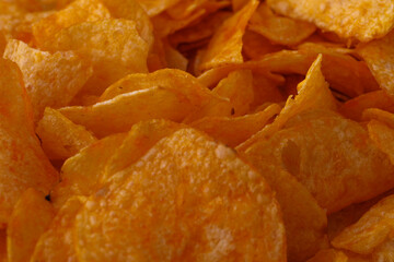 Potato chips or crisps . Close-up of potato chips or crisps. Food background.