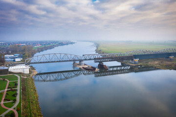 Fototapeta premium Aerial landscape of the Vistula river and railway bridge in Tczew, Poland