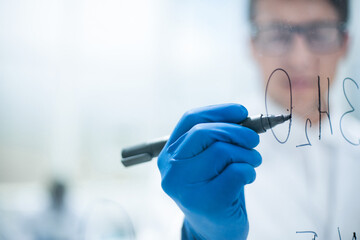 background image.scientist making notes on a transparent Board