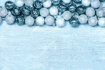 New Year Balls on blue wood background. Christmas background with colorful baubles. Happy New Year greeting card