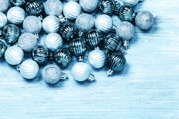 New Year Balls on blue wood background. Christmas background with colorful baubles. Happy New Year greeting card