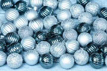 New Year Balls on blue wood background. Christmas background with colorful baubles. Happy New Year greeting card