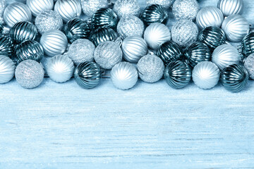 New Year Balls on blue wood background. Christmas background with colorful baubles. Happy New Year greeting card