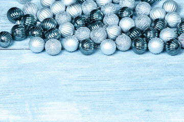 New Year Balls on blue wood background. Christmas background with colorful baubles. Happy New Year greeting card