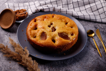 Homemade pear cake, on a tempo gray background.
