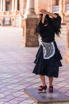 Stock photo of a flamenco dancer dancing and clapping outdoor. Unrecognisable woman dancing and stomping o a flamenco stage or tablao