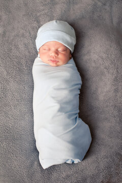 Newborn Baby Sleeping Peacefully While Swaddled in Blanket, Color Portrait