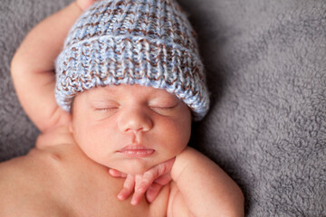 Newborn Baby Sleeping Peacefully in Knit Hat, Color Portrait