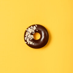 Sweet donut on yellow background. Top view. Flat lay. Food concept.