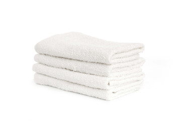 several white beach cotton towels folded on white background