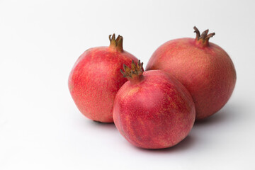 Whole pomegranate in studio on white background