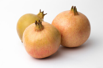 Whole pomegranate in studio on white background