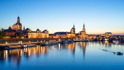 Panorama of the famous historical old town of Dresden located in Saxony and the river Elbe during during blue hour. Famous sights of the city Dresden illuminated in the evening.