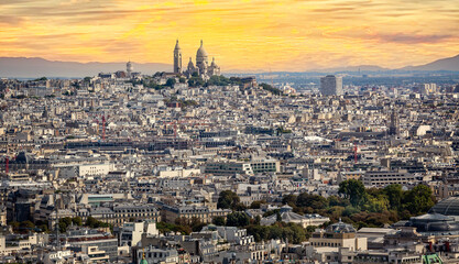 Basilica of the Sacred Heart on the summit of Montmartre seen from the Eifel Tower at sunset in...